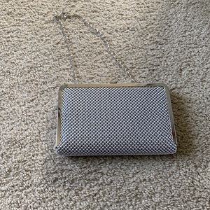 Silver beaded clutch with strap.